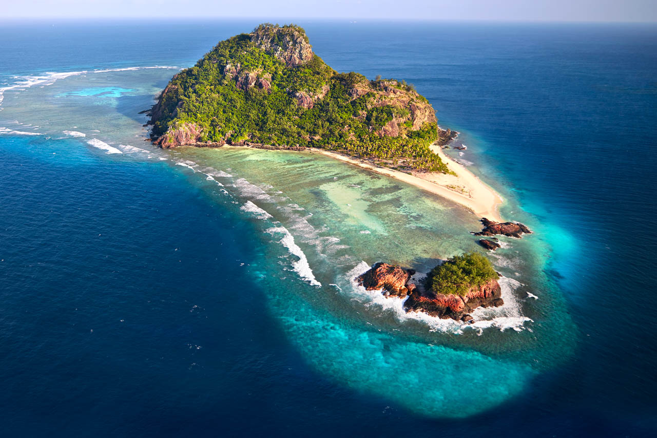 Aerial view of Monuriki Island, known from the film "Cast Away", with surrounding coral reefs in Fiji.